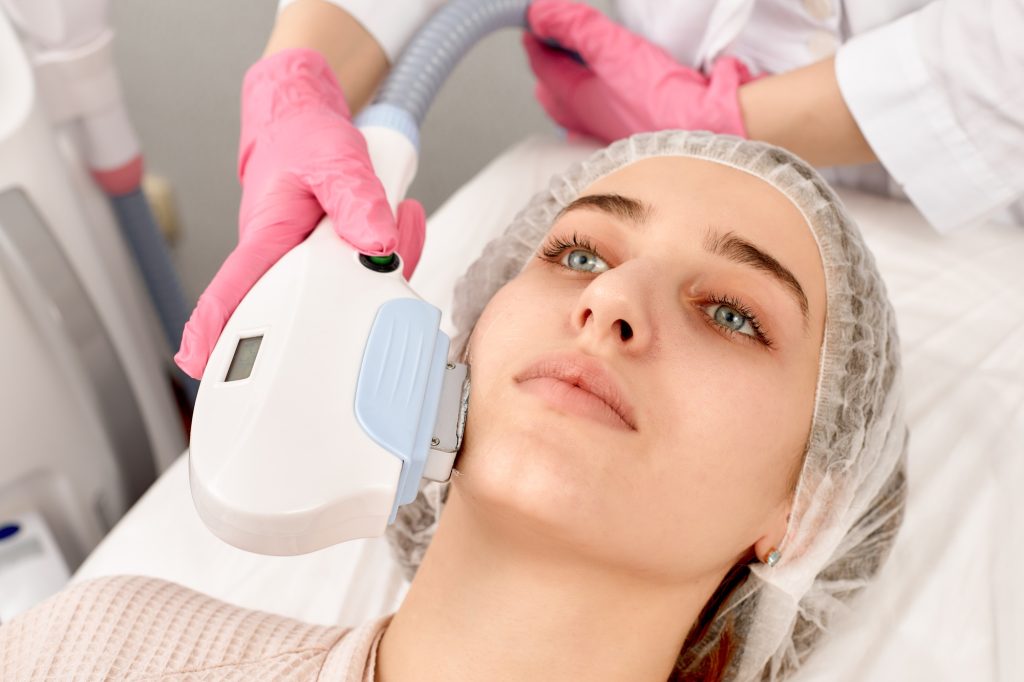 procedure of photoepilation in the beauty salon. Young Woman Receiving Epilation Laser Treatment On